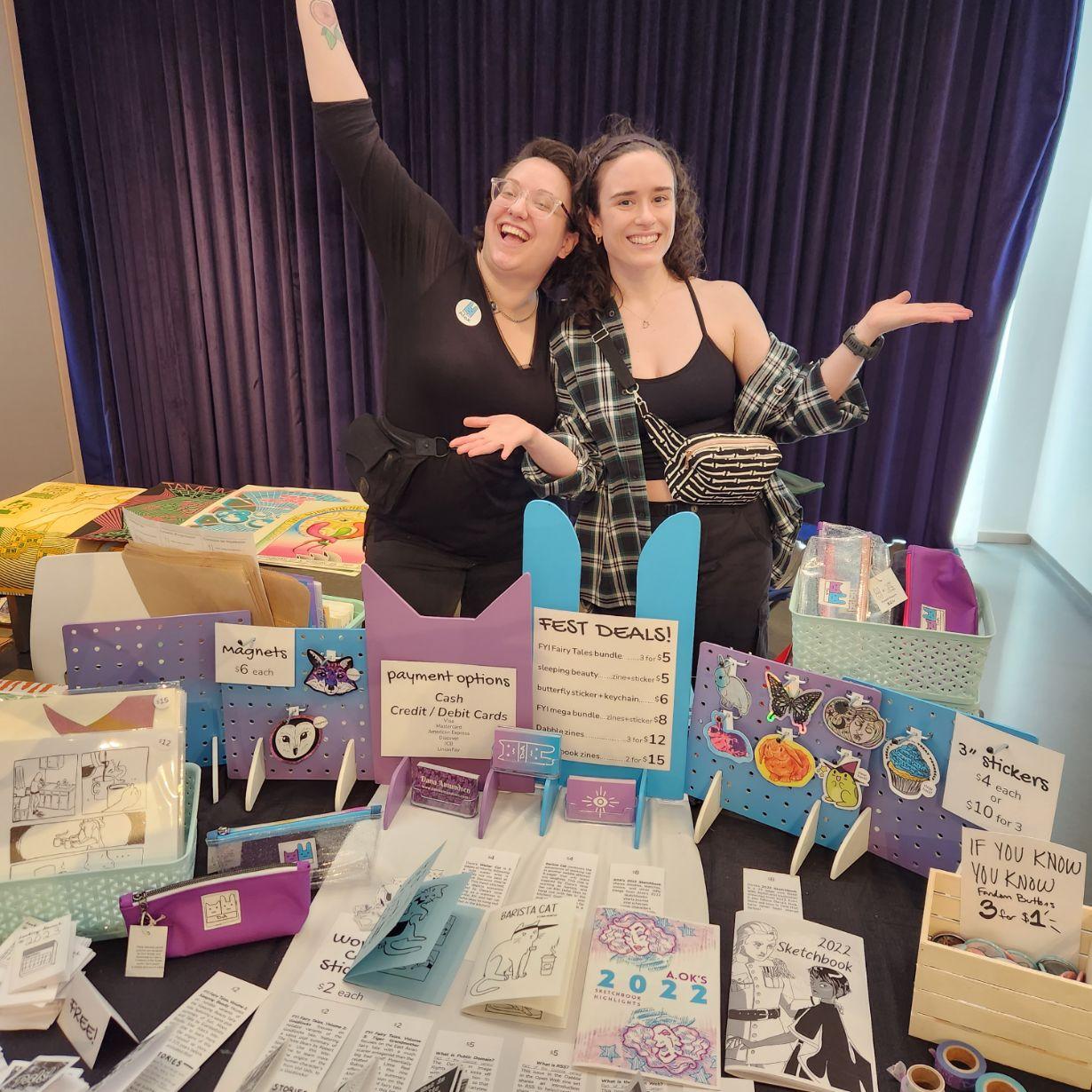 photograph of dana and alex standing behind their colorful table display