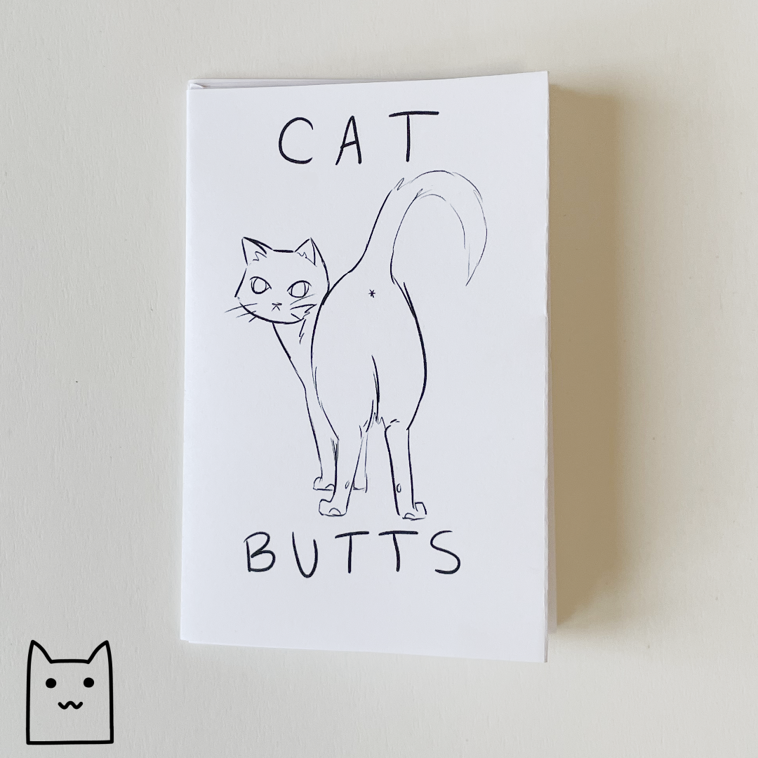 A photo of Cat Butts, a zine by Dana Amundsen. The cover shows a cat looking over her shoulder.