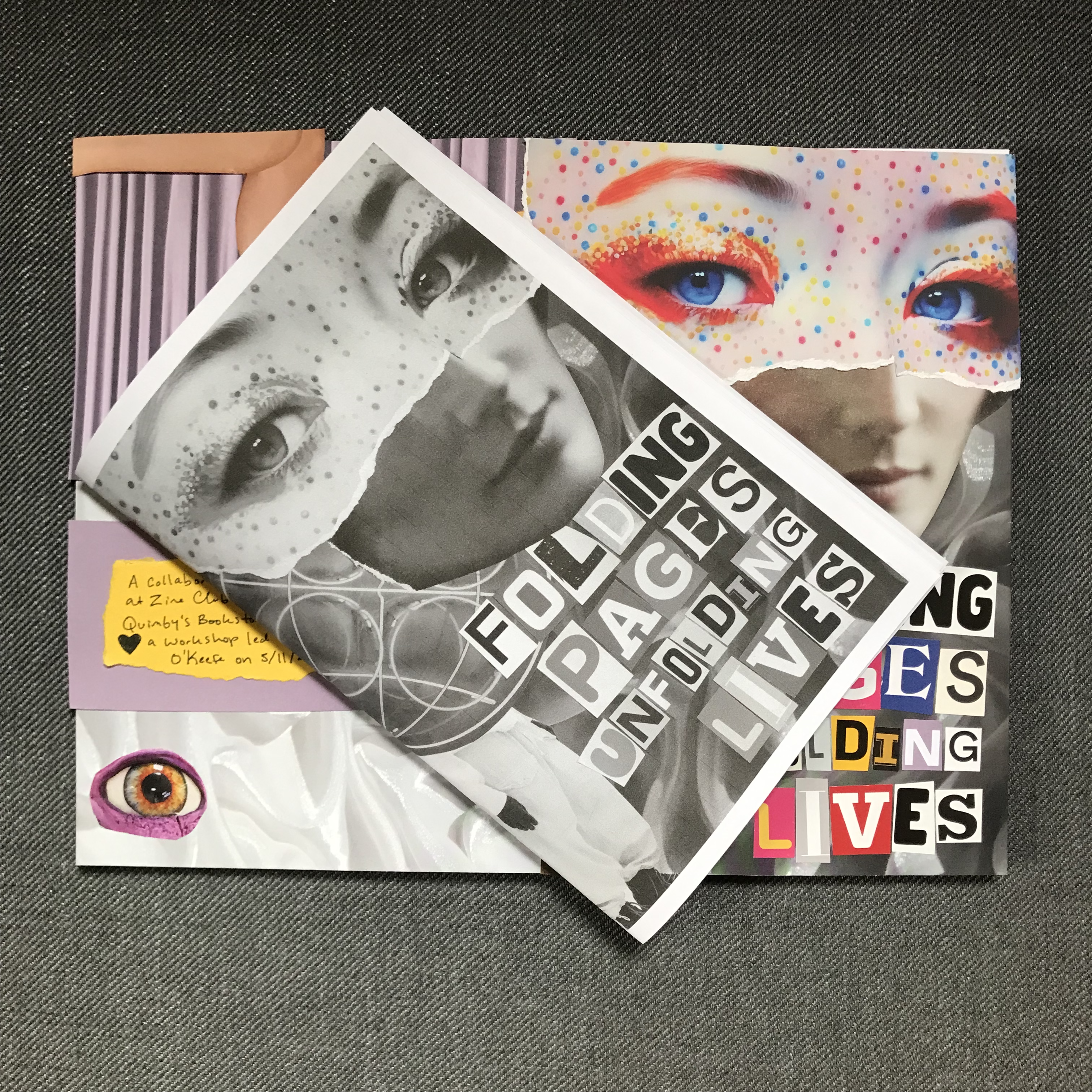 A photo of the 'folding pages unfolding lives' zine on top of the collaged cover on a grey background.' zine.