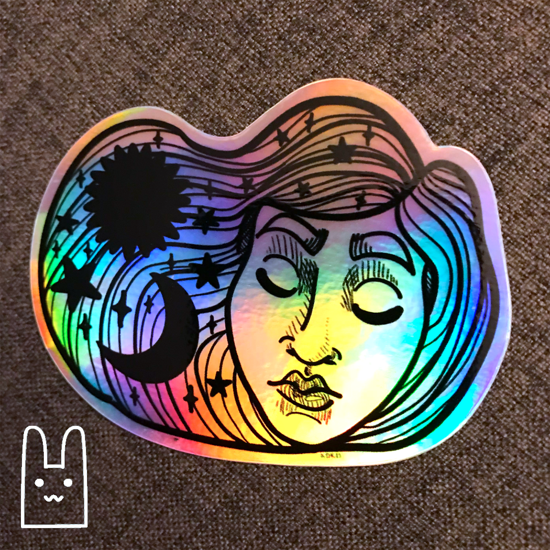 A photo of a holographic Sleeping Beauty sticker by Alex O'Keefe