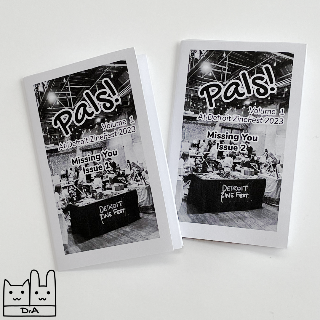A photo of two mini zines with 'Pals! Volume 1 At Detroit ZineFest 2023. Missing You, Issue 1' and 'Issue 2' written on the cover.