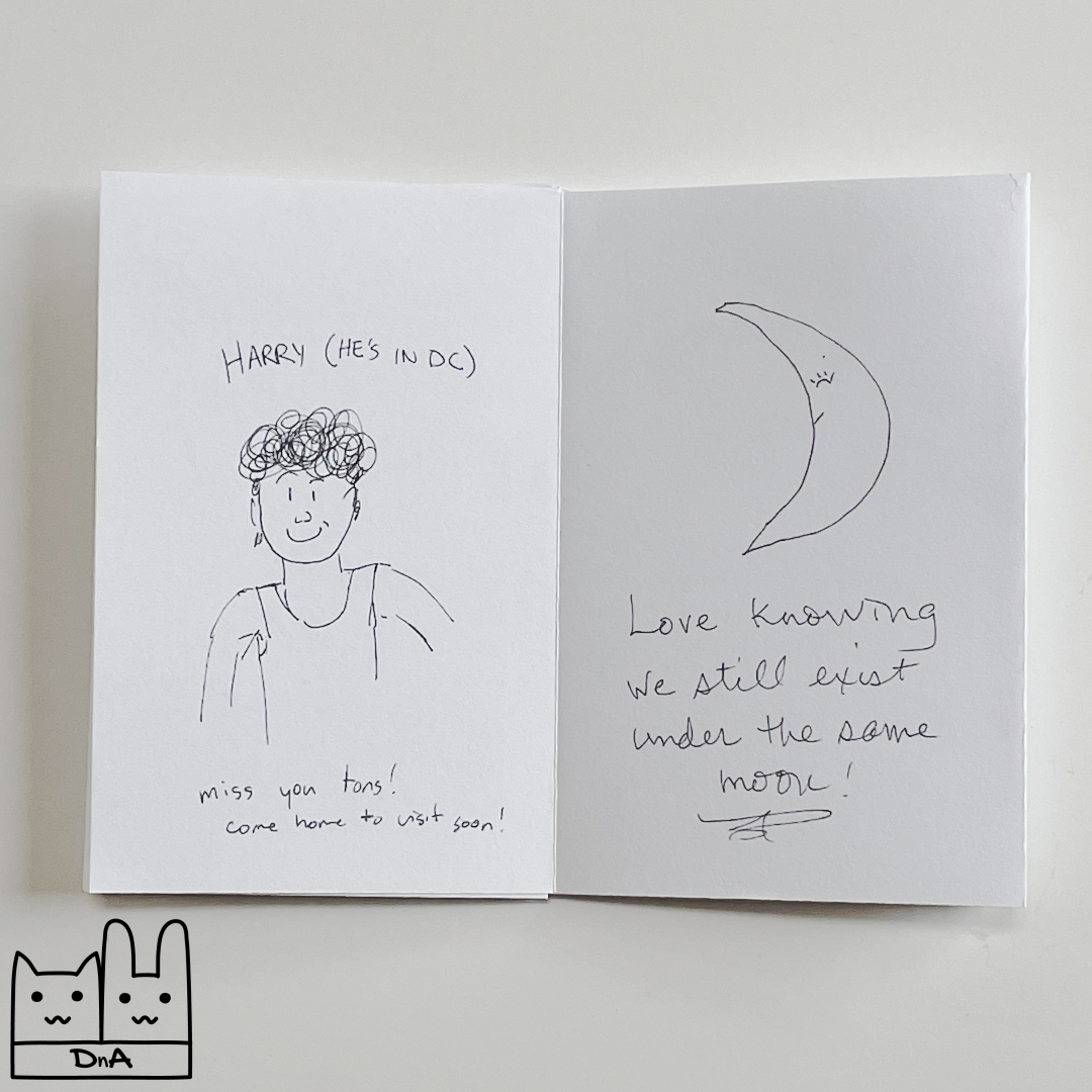 A photo of the interior of issue 2 showing a drawing of a person with the caption 'Harry (he's in DC) miss you tons! come home to visit soon!' and a moon with the caption 'Love knowing we still exist under the same moon!'
