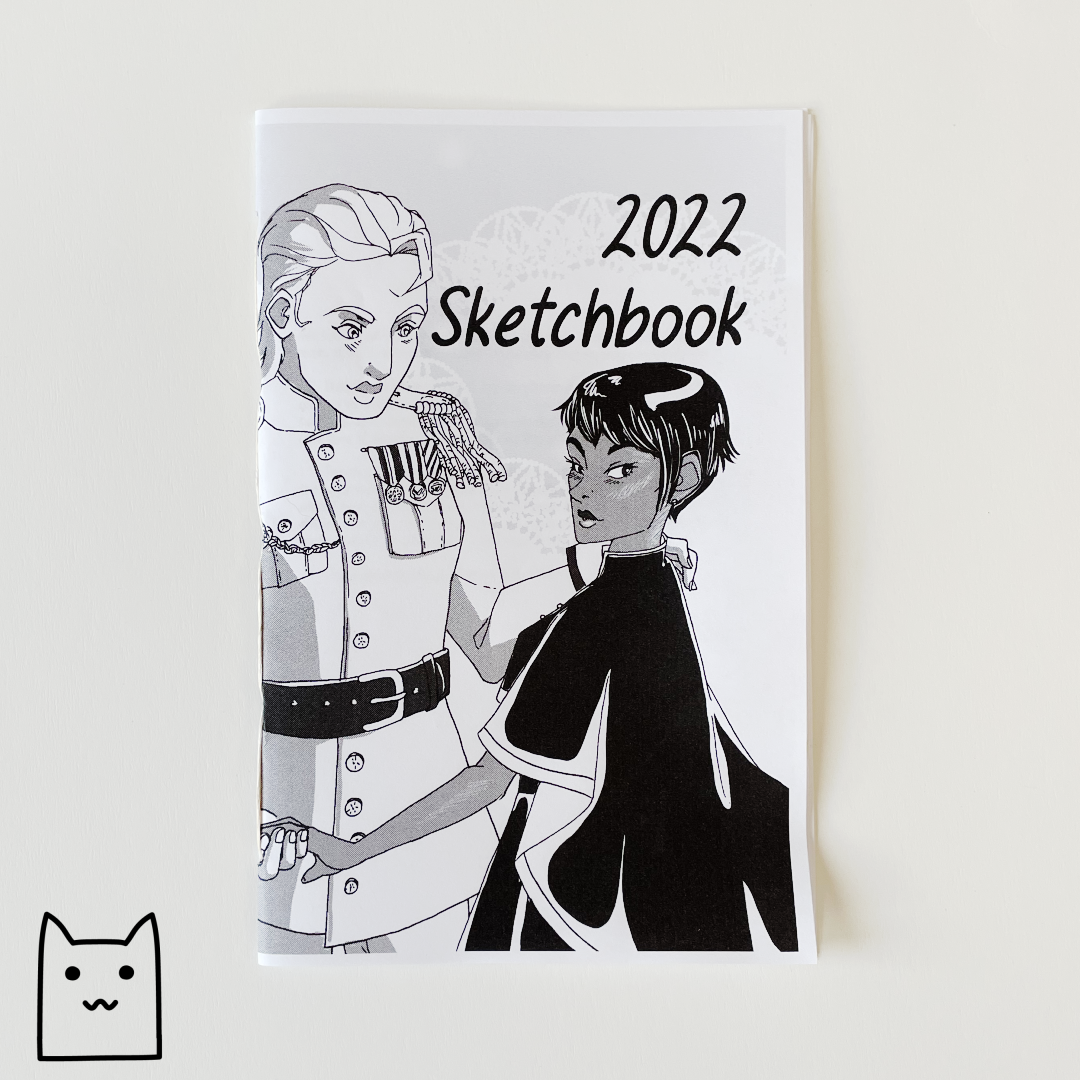 A photo of the cover of 2022 Sketchbook, by Dana Amundsen. The cover features Dana’s original characters Tove and Merri dancing together. Merri is wearing a white military uniform and Tove is wearing black robes.